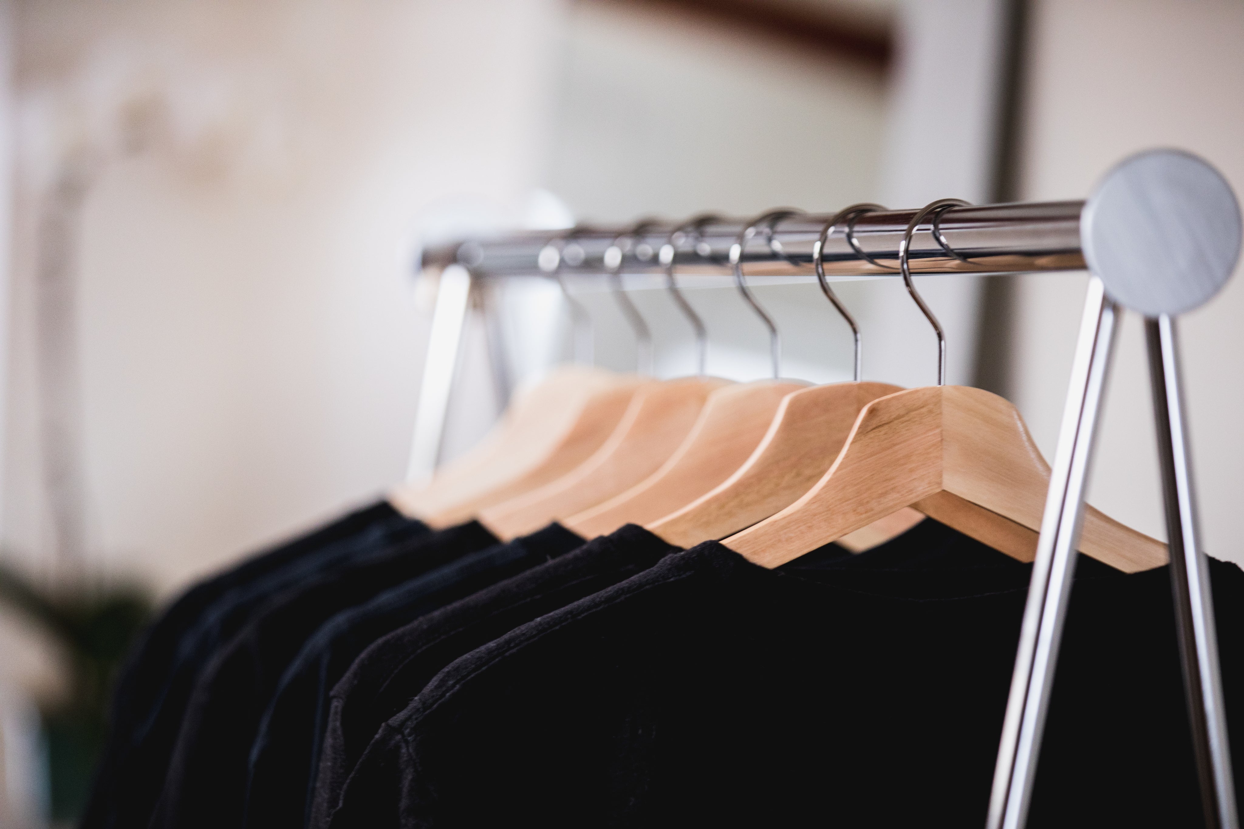 black-and-blue-clothing-on-a-rack-in-a-sunlit-shop.jpg